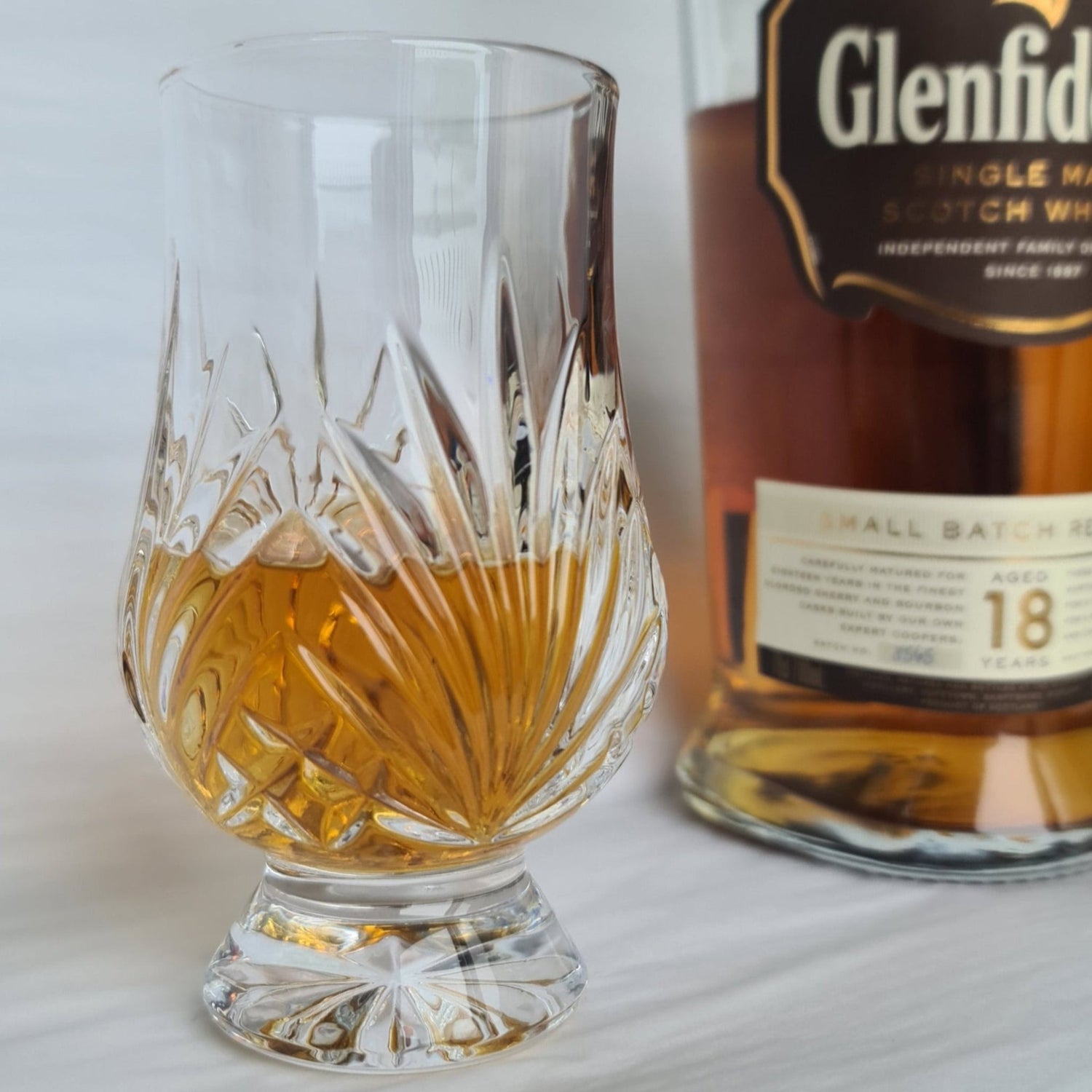 Oblique Cut Crystal Whisky Glass and Bottle of Whisky